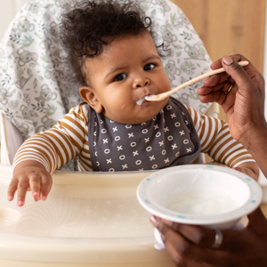 Baby in highchair eating Baby in highchair eating