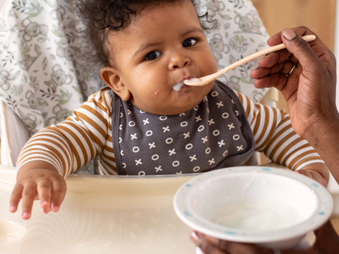 Baby in highchair eating Baby in highchair eating